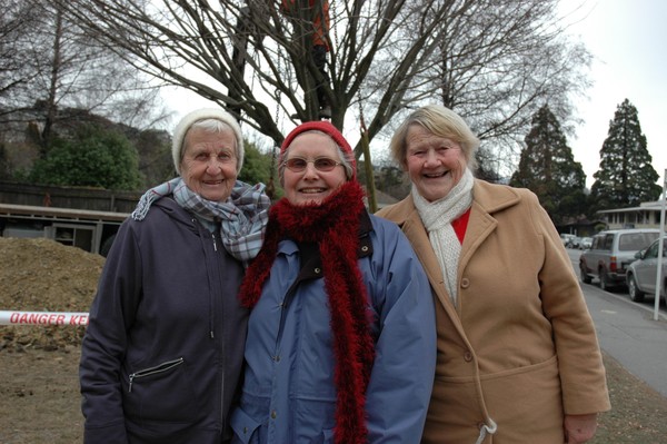 Elm Tree Ladies from left Donalda Anderson, Francis Lewis and Joan Cooke as workmen slot the special commemorative Elm into place. 